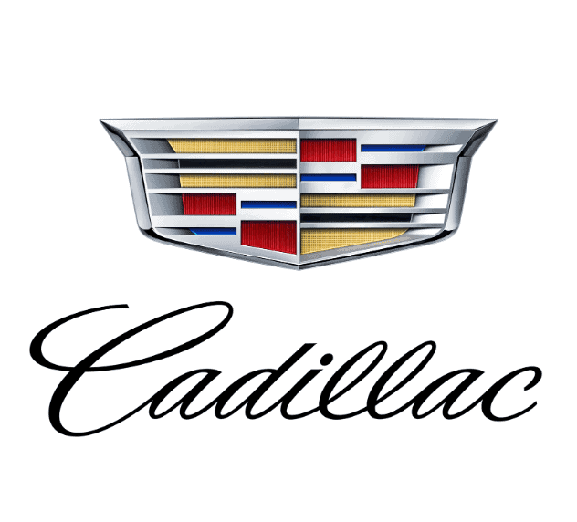 Das Emblem besteht aus einem aufwendig gestalteten Wappen mit silbernem Rahmen und farbigen Elementen in Rot, Blau, Gold und Schwarz. Unterhalb befindet sich der elegante Schriftzug Cadillac in geschwungener, schwarzer Schreibschrift. Das Logo vermittelt Luxus und Exklusivität.