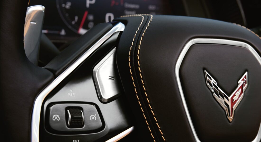 Corvette C8 Stingray - Lenkrad und Schaltpaddles Detailaufnahme des Corvette-Lenkrads mit Schaltwippe und Corvette-Emblem